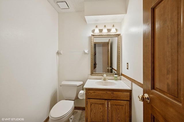 bathroom with visible vents, tile patterned floors, baseboards, vanity, and toilet