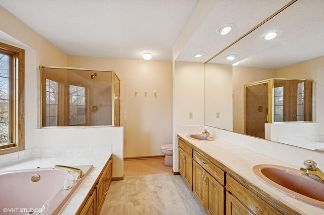 full bathroom with a sink, a stall shower, recessed lighting, and a garden tub