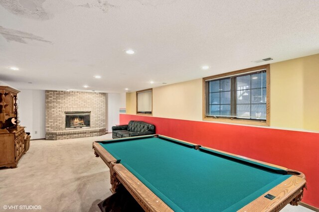 game room featuring a brick fireplace, pool table, visible vents, and carpet