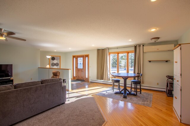 17367 Gull Lake Loop Rd NE, Bemidji, MN 56601 - living room featuring light wood-style floors, a wall mounted AC, recessed lighting, ceiling fan, and a textured ceiling