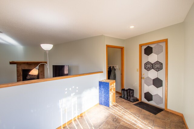 17367 Gull Lake Loop Rd NE, Bemidji, MN 56601 - bar area with a tile fireplace, recessed lighting, stone finish flooring, and baseboards
