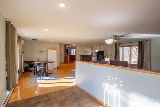 17367 Gull Lake Loop Rd NE, Bemidji, MN 56601 - kitchen featuring a baseboard radiator, recessed lighting, a ceiling fan, fridge, and wood finished floors
