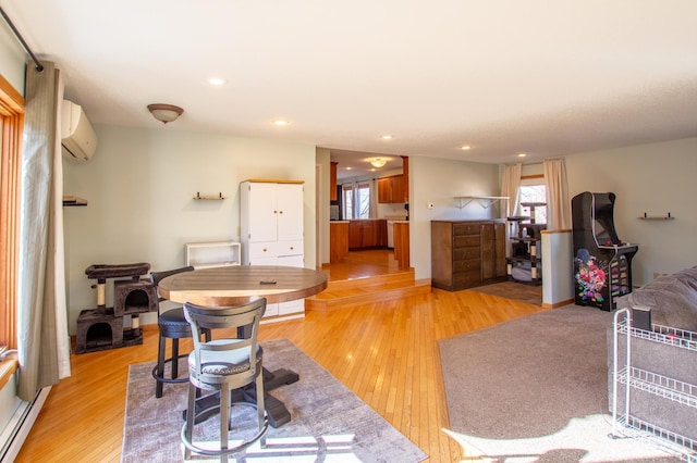17367 Gull Lake Loop Rd NE, Bemidji, MN 56601 - living area featuring a wall mounted air conditioner, healthy amount of natural light, light wood-style flooring, a baseboard radiator, and recessed lighting