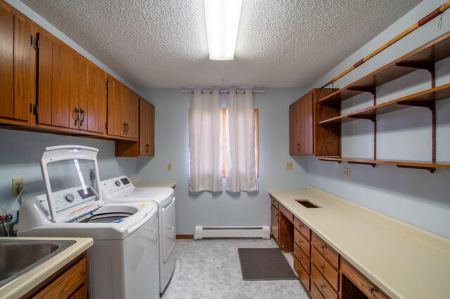 17367 Gull Lake Loop Rd NE, Bemidji, MN 56601 - laundry room featuring a baseboard radiator, washing machine and clothes dryer, a textured ceiling, cabinet space, and baseboards