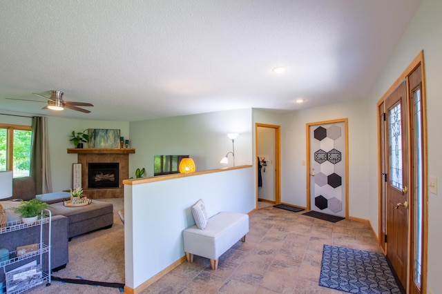 17367 Gull Lake Loop Rd NE, Bemidji, MN 56601 - entryway with a fireplace with raised hearth, baseboards, recessed lighting, and a ceiling fan