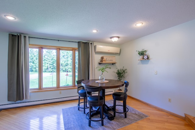 17367 Gull Lake Loop Rd NE, Bemidji, MN 56601 - dining room featuring a wall mounted air conditioner, a textured ceiling, light wood-style floors, a baseboard heating unit, and baseboards