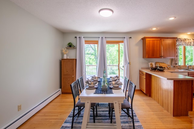 17367 Gull Lake Loop Rd NE, Bemidji, MN 56601 - dining room with a baseboard radiator, a textured ceiling, light wood-type flooring, and recessed lighting