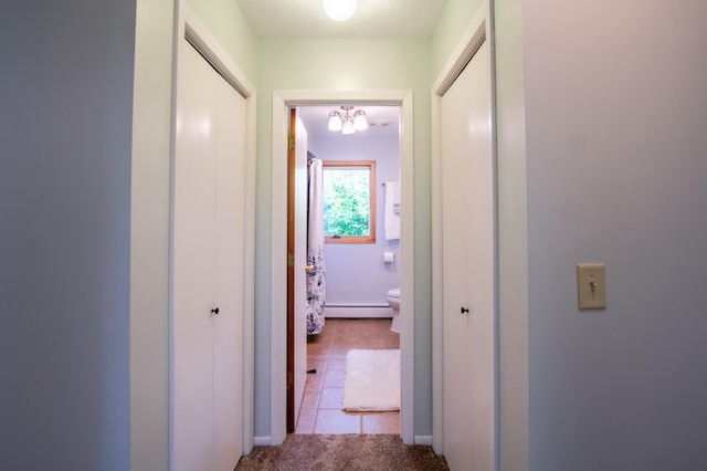 17367 Gull Lake Loop Rd NE, Bemidji, MN 56601 - hall with baseboard heating, carpet, a chandelier, and tile patterned floors
