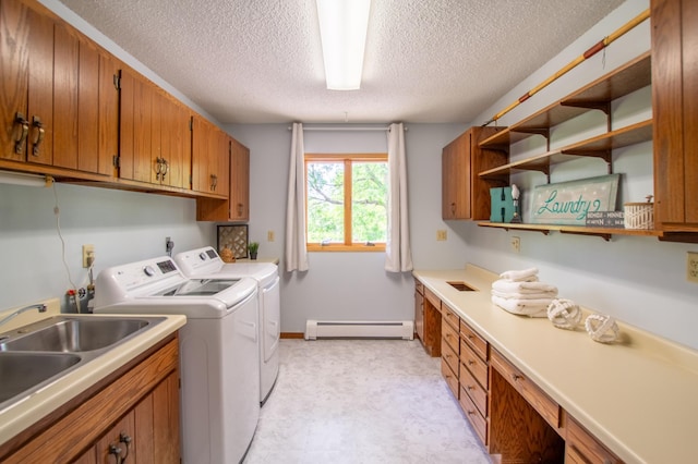 17367 Gull Lake Loop Rd NE, Bemidji, MN 56601 - laundry room with a baseboard radiator, washing machine and clothes dryer, a textured ceiling, light floors, and cabinet space