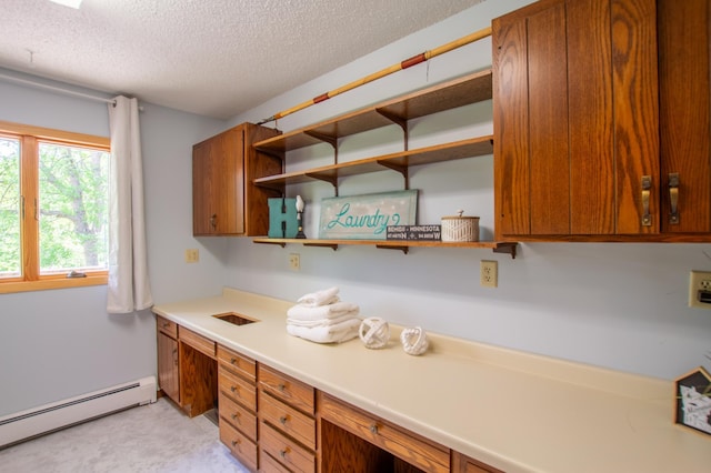 17367 Gull Lake Loop Rd NE, Bemidji, MN 56601 - kitchen featuring a baseboard heating unit, brown cabinets, a textured ceiling, open shelves, and light countertops