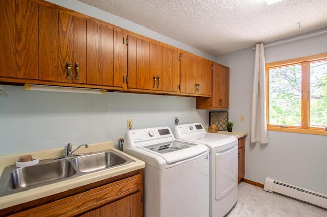 17367 Gull Lake Loop Rd NE, Bemidji, MN 56601 - laundry area featuring a baseboard radiator, cabinet space, washing machine and clothes dryer, a textured ceiling, and baseboards