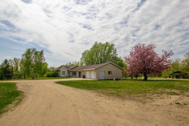 17367 Gull Lake Loop Rd NE, Bemidji, MN 56601 - view of front of property with dirt driveway, an attached garage, and central AC unit