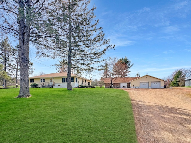 view of front facade with a garage, dirt driveway, and a front yard