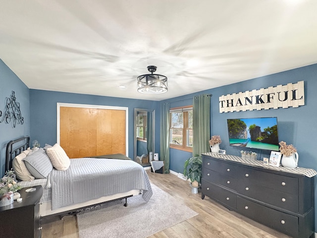 bedroom with baseboards and wood finished floors