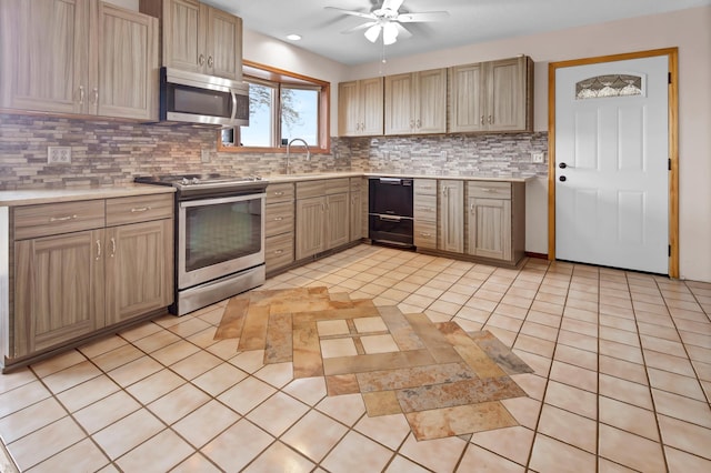 kitchen with ceiling fan, light countertops, backsplash, and appliances with stainless steel finishes
