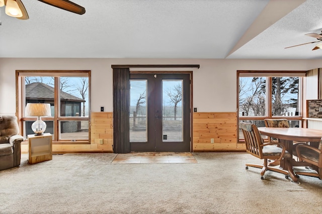interior space featuring ceiling fan, a wealth of natural light, french doors, and a textured ceiling