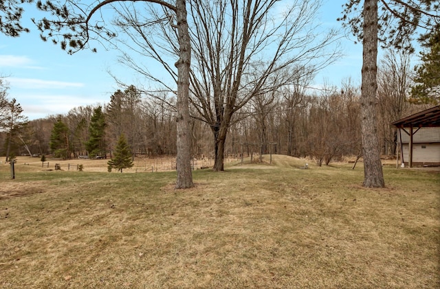 view of yard with a view of trees