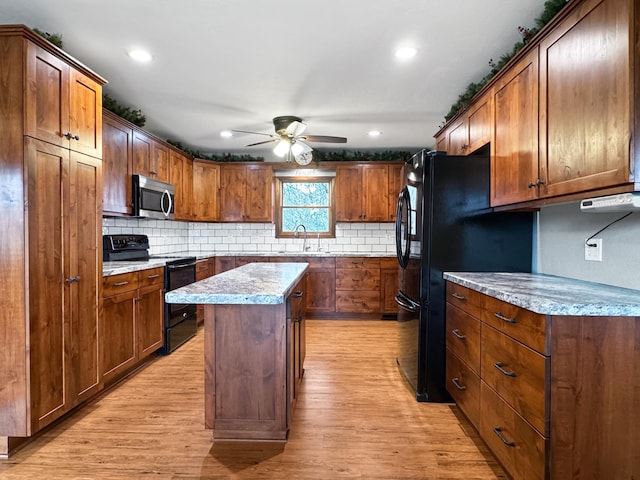 1126 US Highway 59, Garvin, MN 56132 - kitchen with black appliances, light wood-type flooring, ceiling fan, decorative backsplash, and recessed lighting