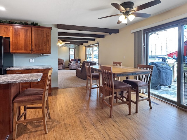 1126 US Highway 59, Garvin, MN 56132 - dining space featuring a ceiling fan, light wood finished floors, and beamed ceiling