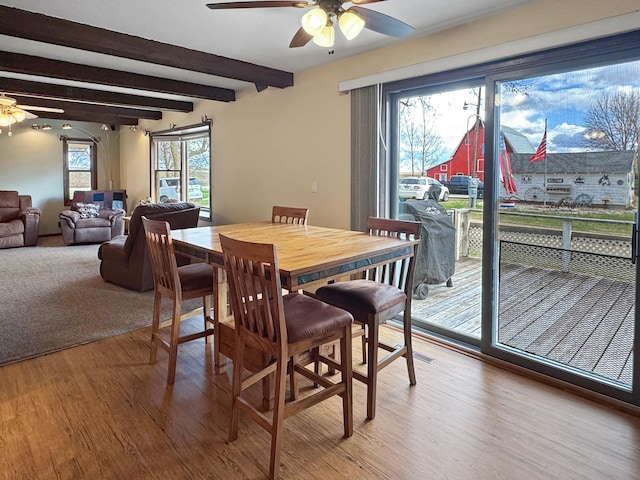 1126 US Highway 59, Garvin, MN 56132 - dining area featuring a ceiling fan, light wood-style flooring, and beamed ceiling