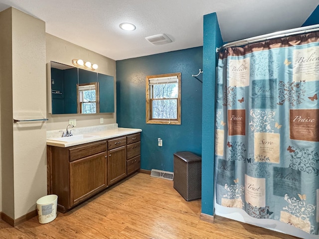 1126 US Highway 59, Garvin, MN 56132 - bathroom featuring vanity, wood finished floors, a shower with curtain, and a textured ceiling