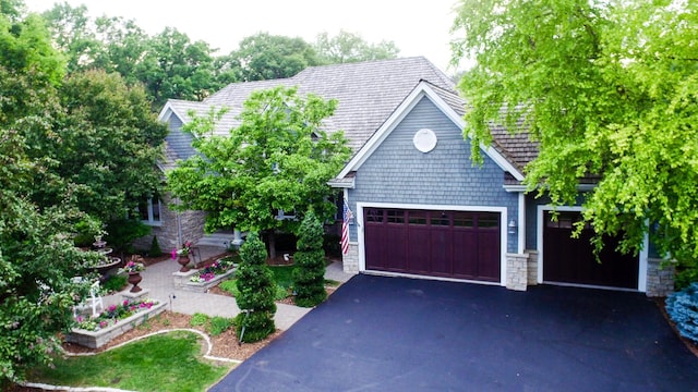 13980 Emerald Rdg, Minnetonka, MN 55305 - view of front of property featuring stone siding, asphalt driveway, and a garage