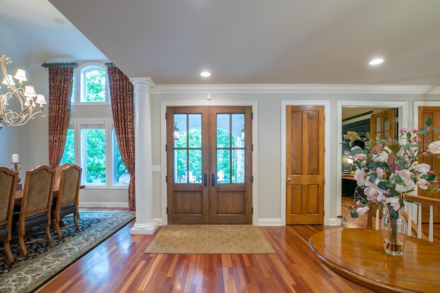 13980 Emerald Rdg, Minnetonka, MN 55305 - entrance foyer with wood finished floors, french doors, a chandelier, ornamental molding, and decorative columns