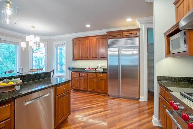 13980 Emerald Rdg, Minnetonka, MN 55305 - kitchen featuring appliances with stainless steel finishes, light wood-style flooring, ornamental molding, brown cabinetry, and a chandelier