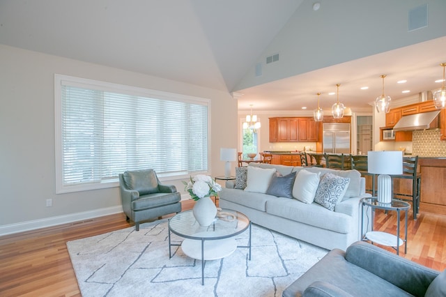 13980 Emerald Rdg, Minnetonka, MN 55305 - living area featuring light wood finished floors, lofted ceiling, recessed lighting, and a chandelier