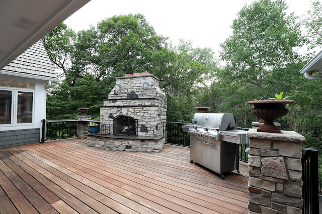 13980 Emerald Rdg, Minnetonka, MN 55305 - deck featuring an outdoor stone fireplace, a grill, and view of scattered trees
