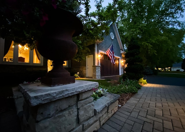 13980 Emerald Rdg, Minnetonka, MN 55305 - view of home's exterior featuring a fireplace and stone siding