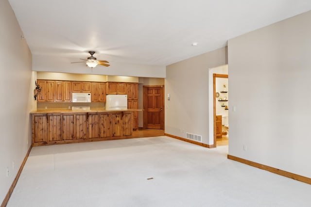 36306 Pine Bay Cir Unit 104, Crosslake, MN 56442 - unfurnished living room with a ceiling fan, baseboards, and light colored carpet