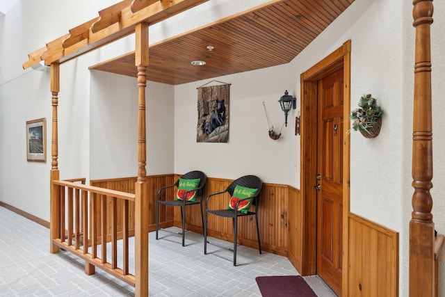36306 Pine Bay Cir Unit 104, Crosslake, MN 56442 - hall featuring wainscoting, brick patterned floors, wood ceiling, and wood walls
