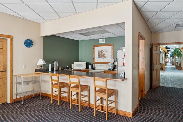 36306 Pine Bay Cir Unit 104, Crosslake, MN 56442 - bar area with white appliances, carpet floors, a drop ceiling, and baseboards
