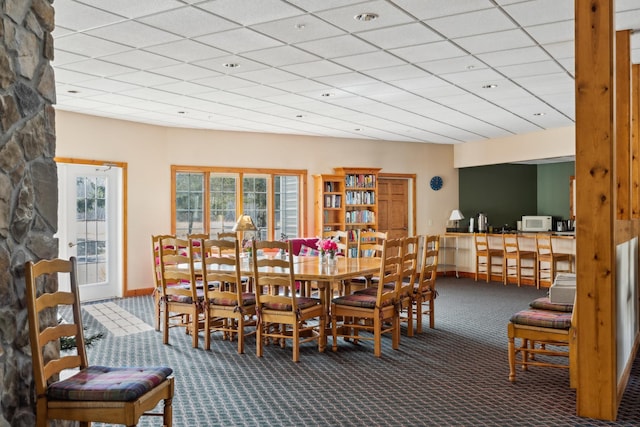 36306 Pine Bay Cir Unit 104, Crosslake, MN 56442 - dining space with carpet floors, baseboards, and a paneled ceiling