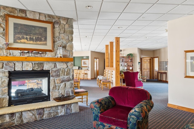36306 Pine Bay Cir Unit 104, Crosslake, MN 56442 - carpeted living room featuring baseboards, a fireplace, and a paneled ceiling