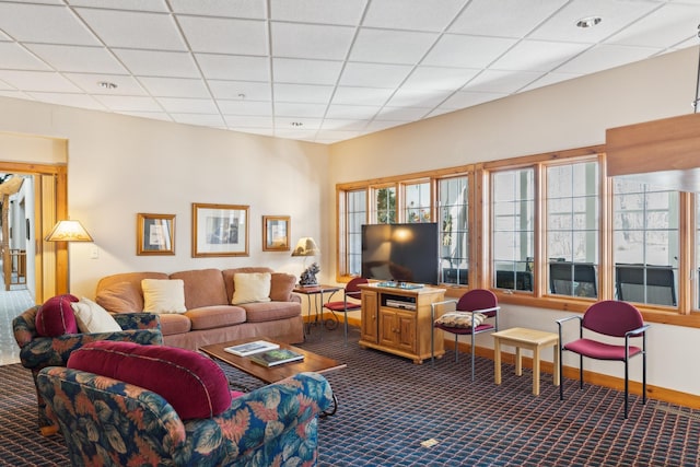 36306 Pine Bay Cir Unit 104, Crosslake, MN 56442 - living area featuring dark carpet, a drop ceiling, and baseboards