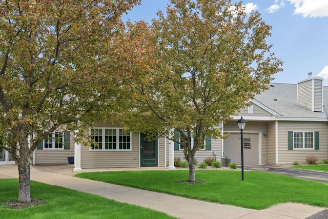 36306 Pine Bay Cir Unit 104, Crosslake, MN 56442 - obstructed view of property featuring driveway, a front yard, a chimney, a garage, and central AC