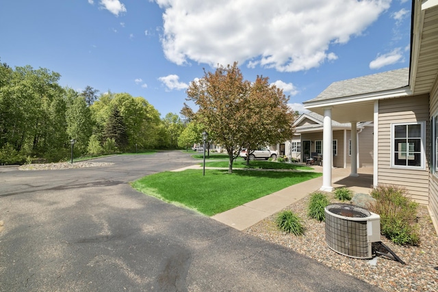 36306 Pine Bay Cir Unit 104, Crosslake, MN 56442 - view of green lawn featuring cooling unit and covered porch