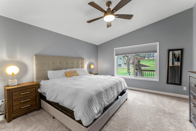 bedroom with light colored carpet, baseboards, ceiling fan, and vaulted ceiling