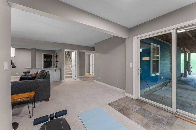 workout room with baseboards and carpet