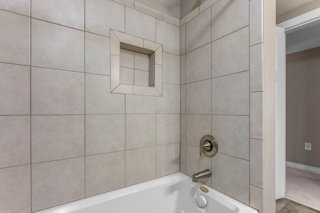 bathroom with baseboards and shower / tub combination