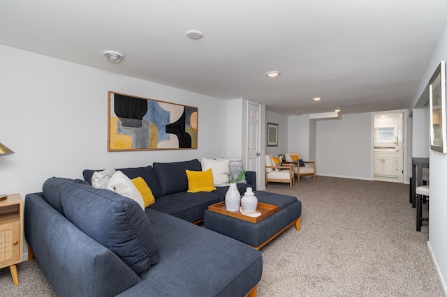 carpeted living area with baseboards and recessed lighting