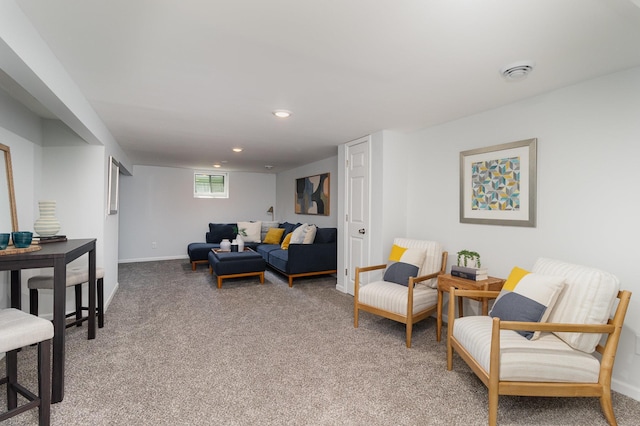 carpeted living area featuring recessed lighting and baseboards