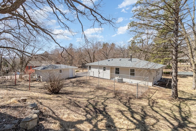 back of house with an outdoor structure, fence, and central AC