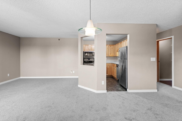 78 10th St E Unit 1410, Saint Paul, MN 55101 - kitchen featuring appliances with stainless steel finishes, open floor plan, dark colored carpet, baseboards, and a textured ceiling