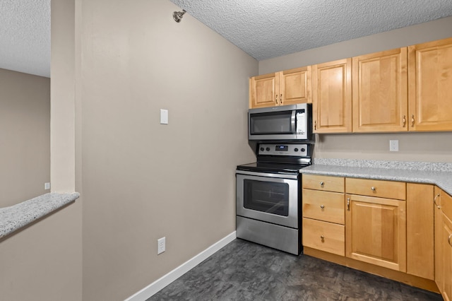 78 10th St E Unit 1410, Saint Paul, MN 55101 - kitchen with appliances with stainless steel finishes, a textured ceiling, light brown cabinetry, light countertops, and baseboards