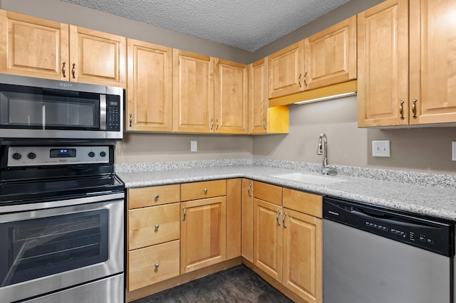 78 10th St E Unit 1410, Saint Paul, MN 55101 - kitchen with appliances with stainless steel finishes, light brown cabinets, a sink, and a textured ceiling