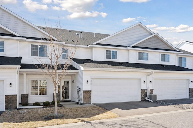 7372 Kalland Cir NE, Otsego, MN 55301 - multi unit property with an attached garage, driveway, and roof with shingles