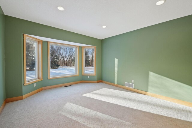 unfurnished room featuring visible vents, baseboards, and carpet floors